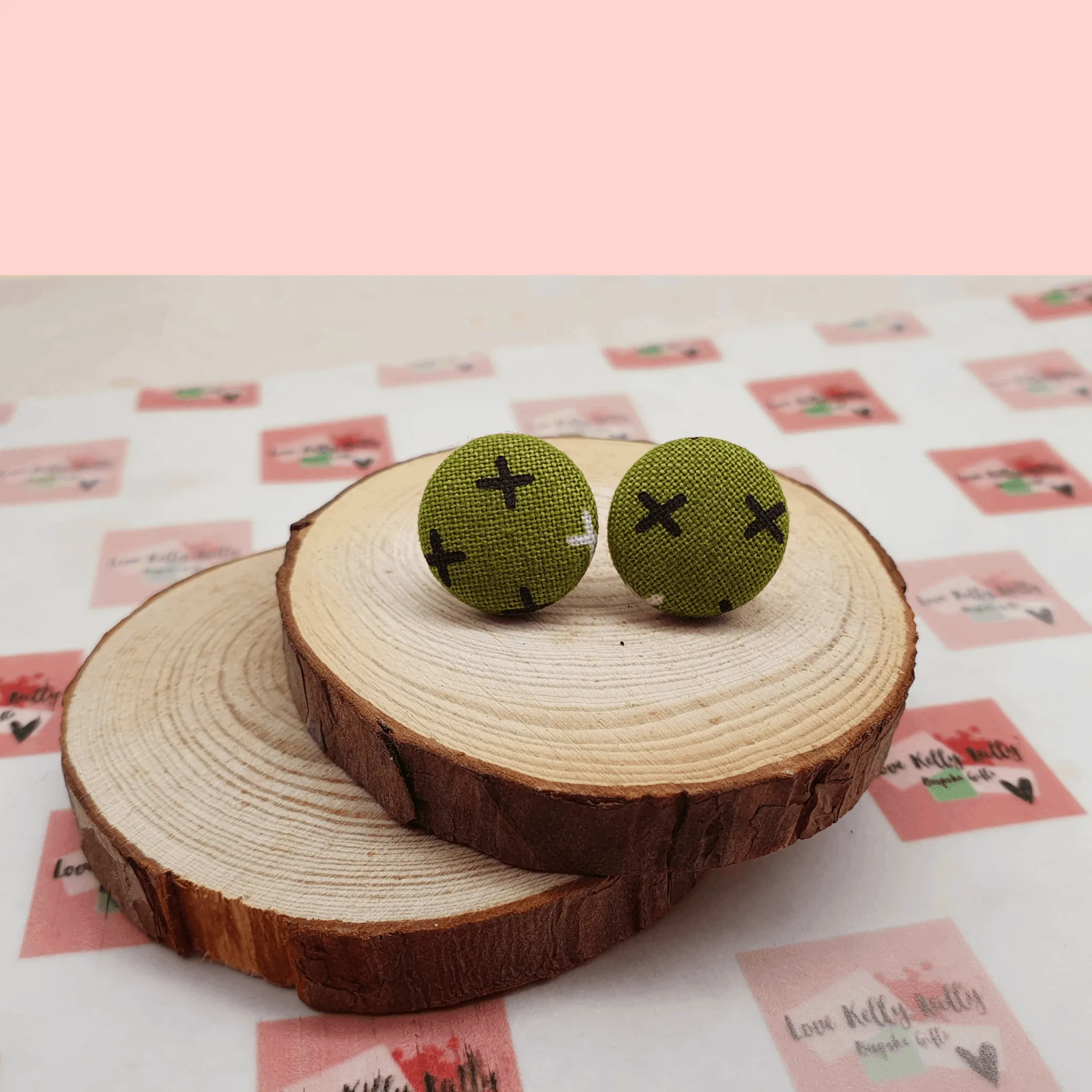 Button stud earrings, edgy cross design.