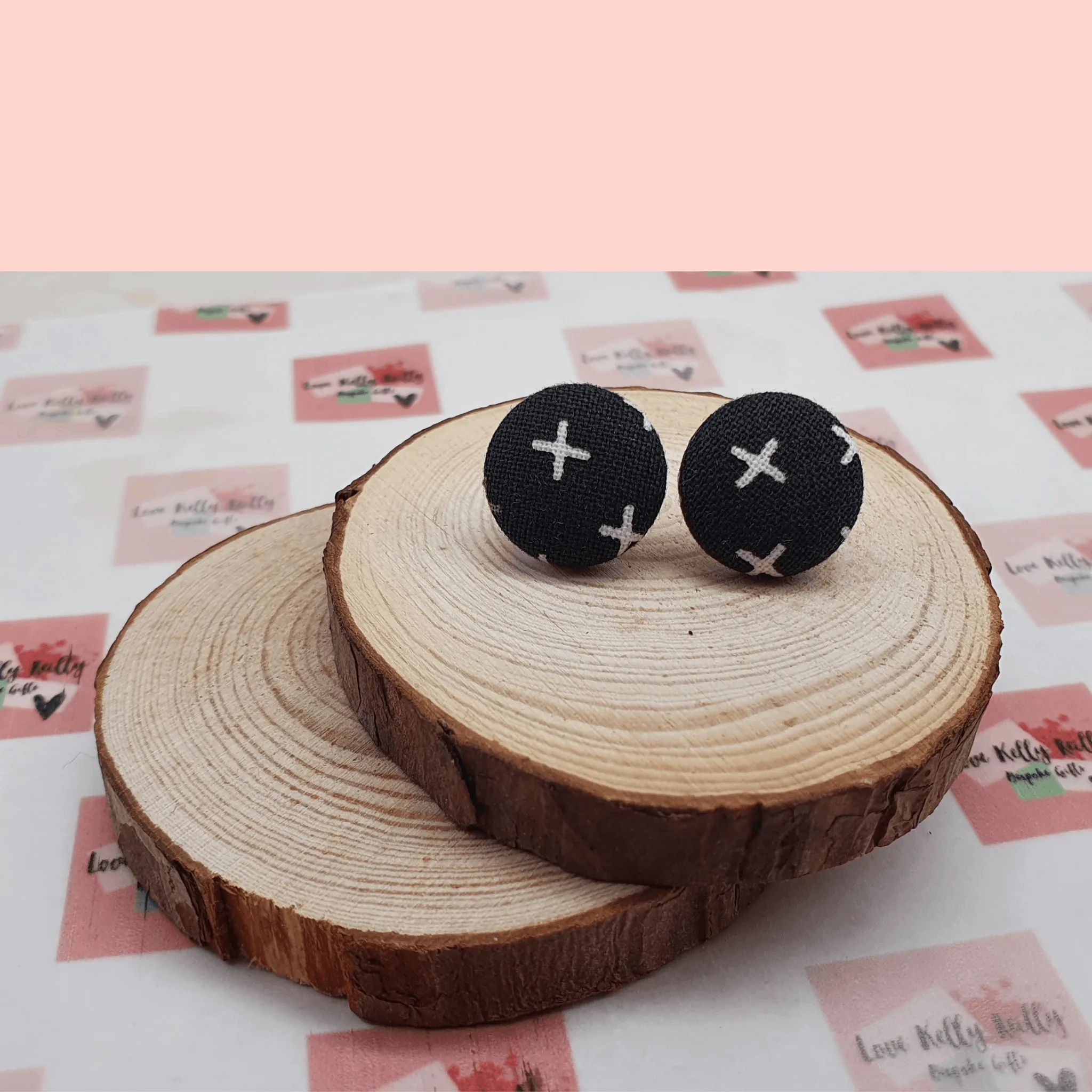 Button stud earrings, edgy cross design.