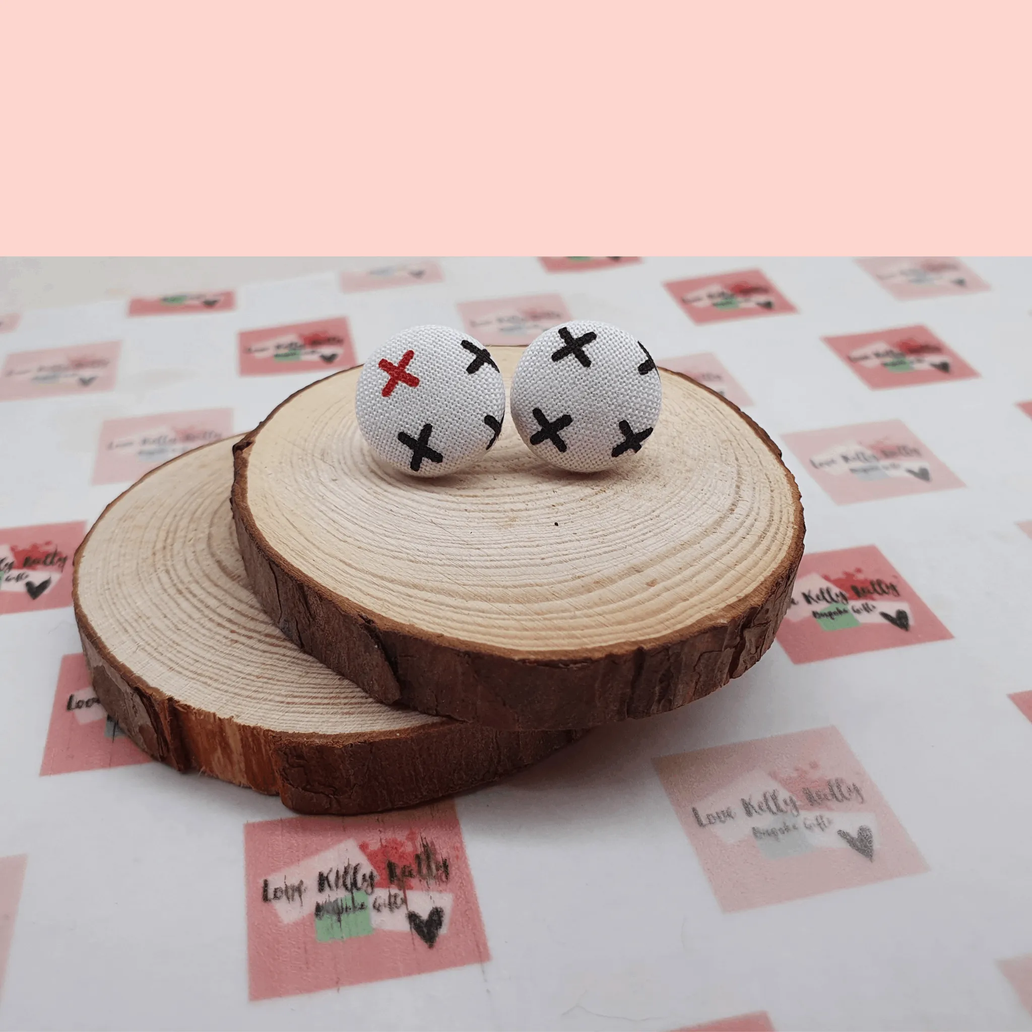 Button stud earrings, edgy cross design.
