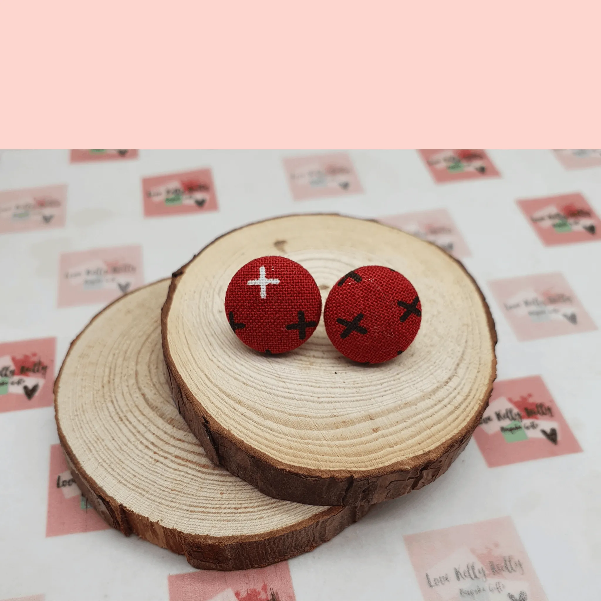 Button stud earrings, edgy cross design.
